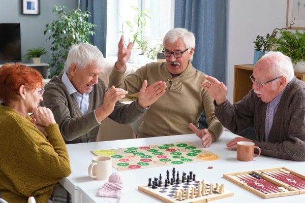 Prestonwood Court | Group of seniors at a table playing games